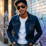 “Confident boy with sunglasses showing attitude.”